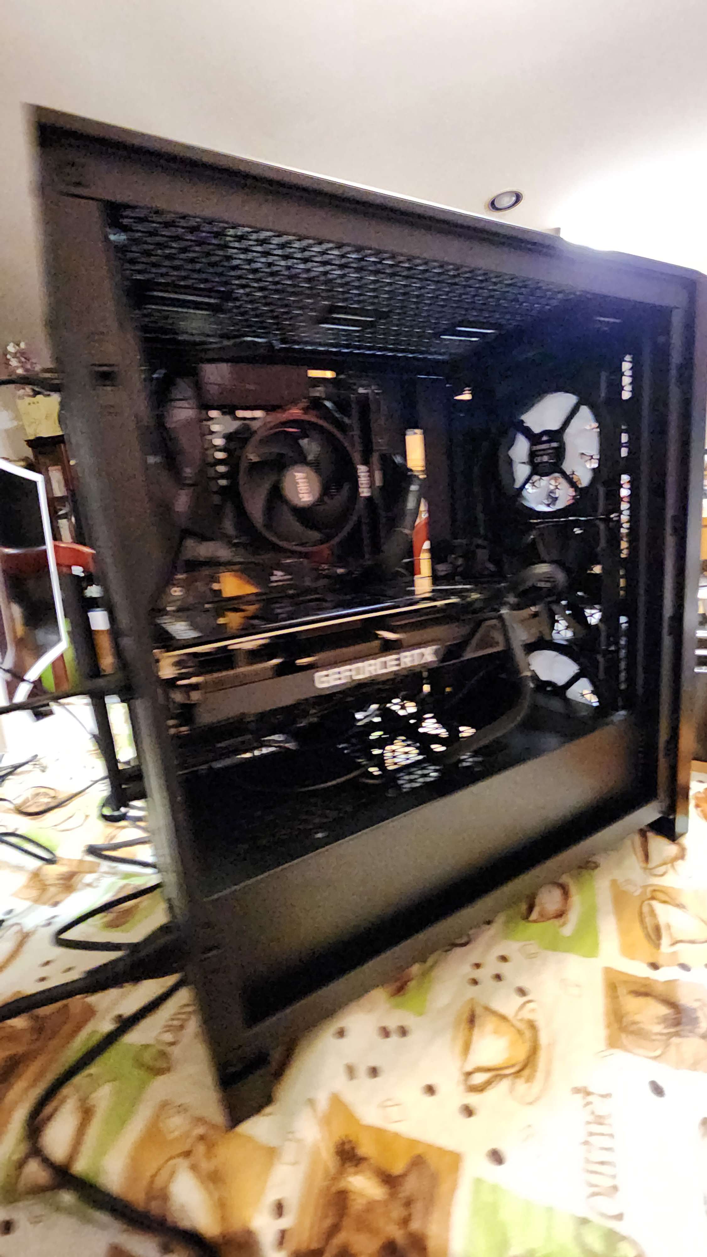 Desktop PC with its graphics card, processor cooler, and case fans visible